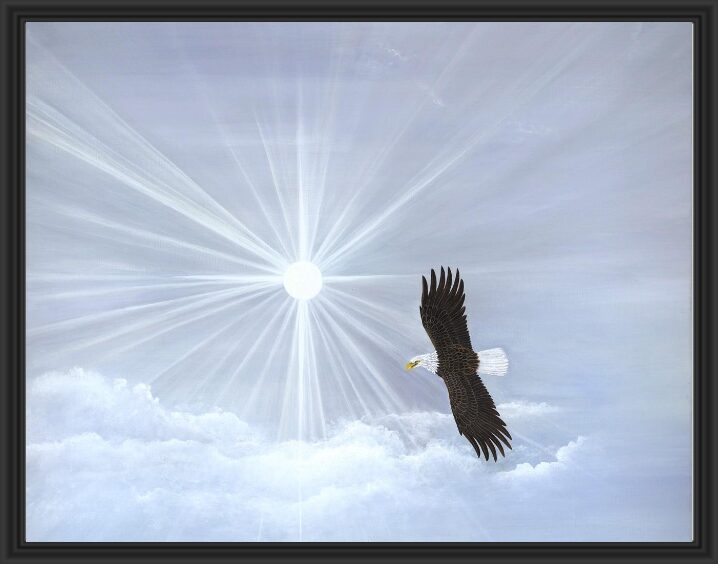 An eagle soaring through a bright, radiant sky filled with soft clouds.