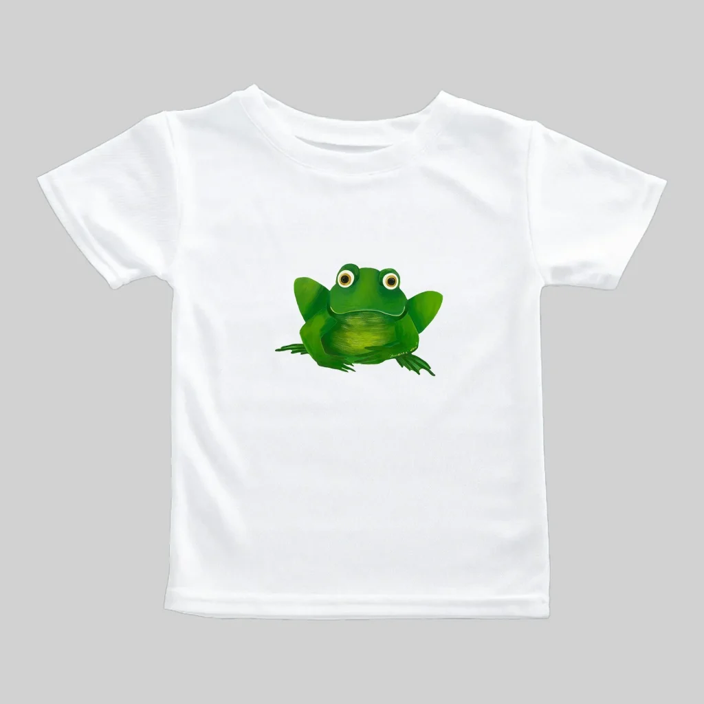 White t-shirt with a cute green frog illustration.
