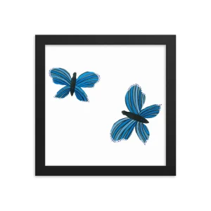 Framed art of two blue butterflies on white background.