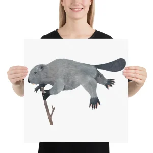 A person holding a poster of a gray beaver illustration.