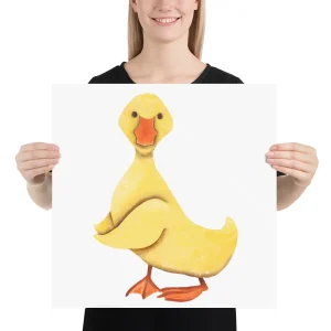 Person holding a poster with a cartoon yellow duck illustration.