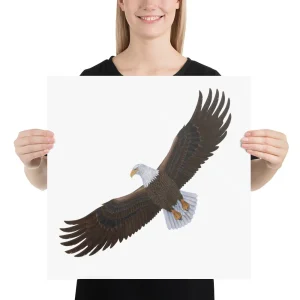 A person holds a square board with a soaring bald eagle illustration.