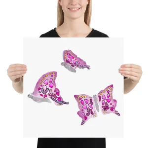 Woman holding poster with colorful butterfly illustrations.