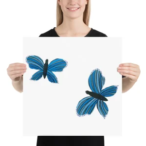 Person holding a white board with two blue butterflies.