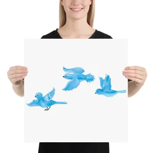 Person holding artwork of four blue birds in flight.