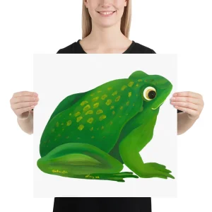 Person holding a large illustration of a green frog.