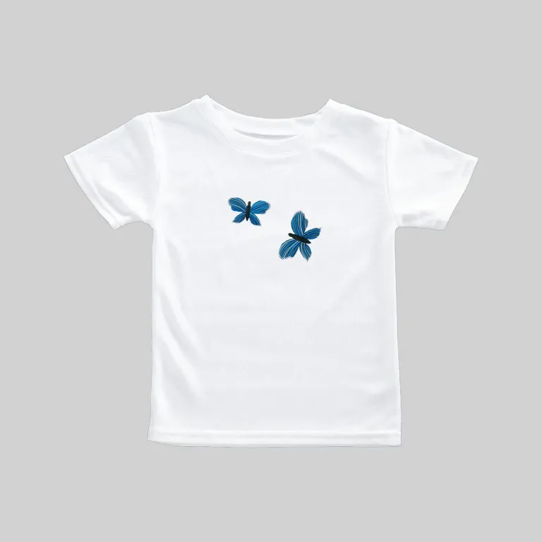 White t-shirt with two blue butterfly prints on the front.