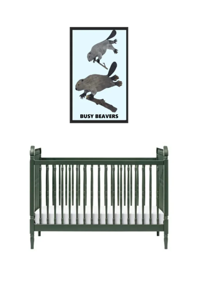 A baby crib with a beaver-themed wall art above it.