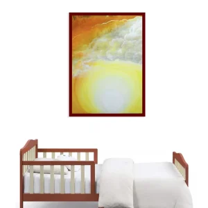 A framed warm sunset painting above a crib in a nursery.