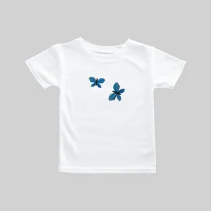 White t-shirt with two blue butterfly prints.