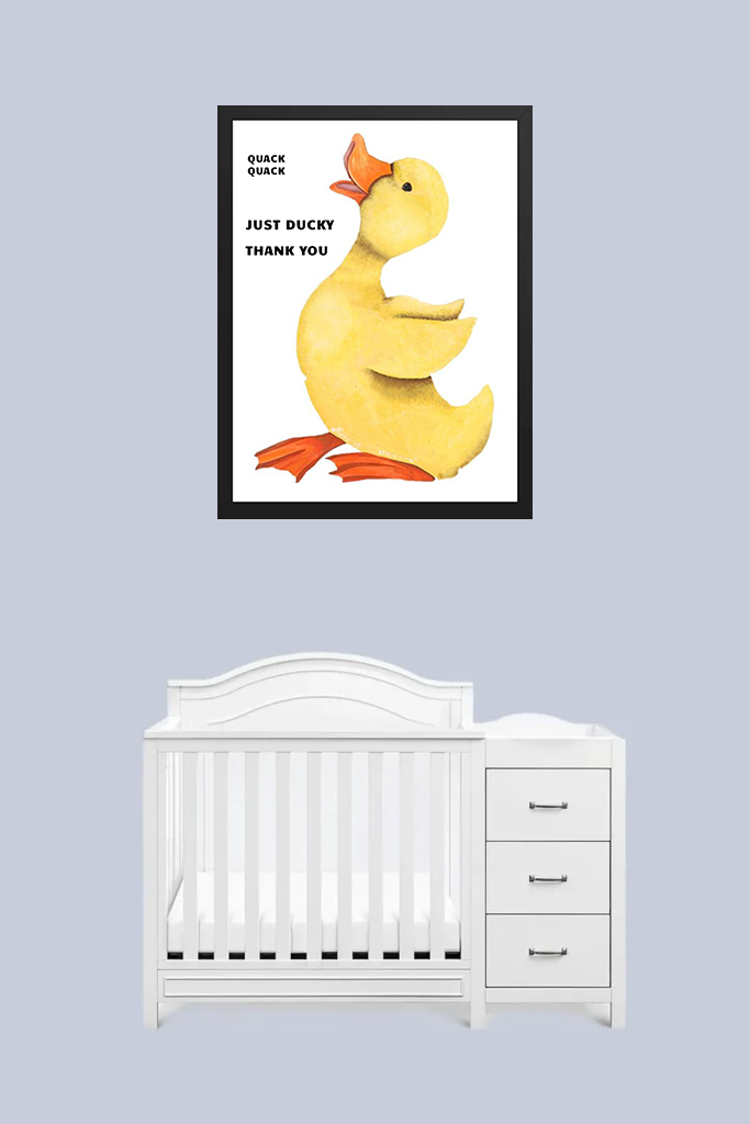 Nursery with white crib and duck-themed wall art.