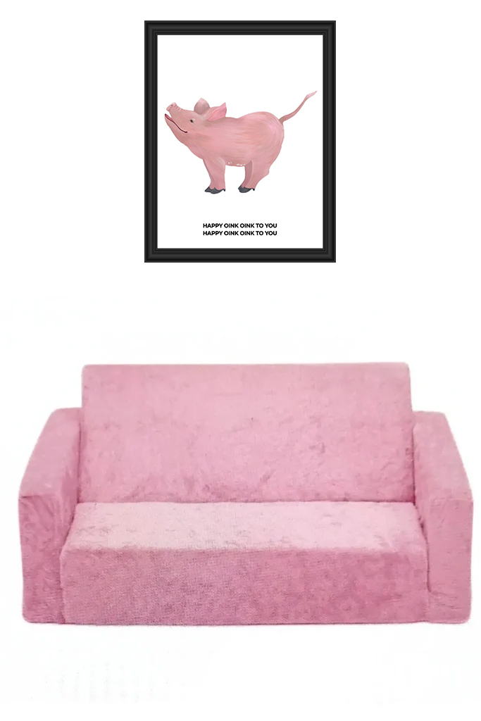 Pink plush sofa with a framed pig artwork above it.