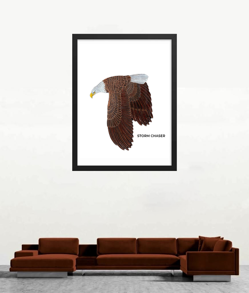 Framed artwork of a brown eagle mid-flight displayed above a brown sofa.